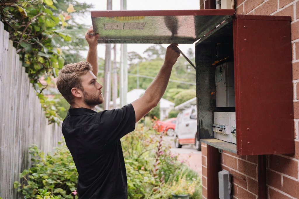 Electrician installing downlights in a Blakehurst home